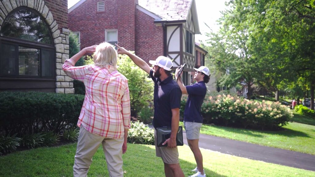 Galati Crew discussing brick work and tuckpointing with a homeowner